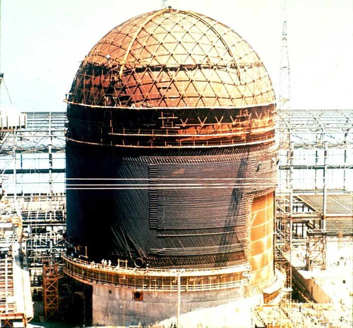 Decommissioning of a nuclear plant, the containment is shown in the picture and is half deconstructed.